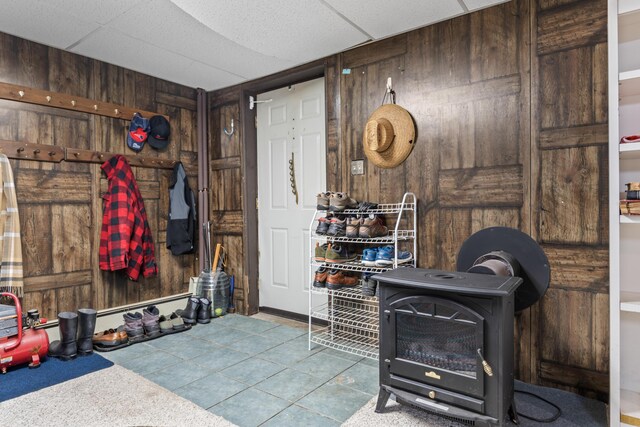 mudroom with wooden walls and tile patterned flooring