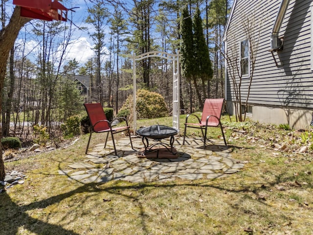 view of yard with a fire pit and a patio