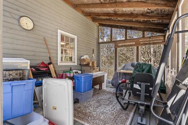 sunroom / solarium featuring beam ceiling