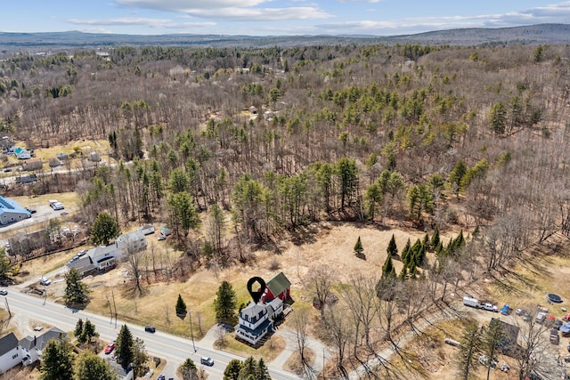 birds eye view of property with a wooded view