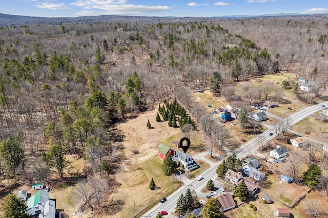 birds eye view of property with a forest view
