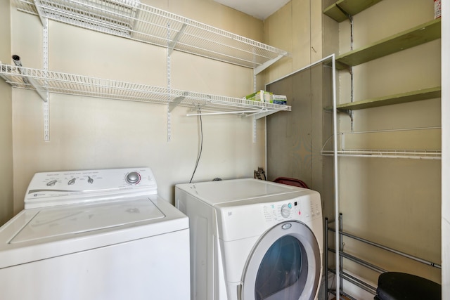 laundry area featuring washing machine and clothes dryer and laundry area