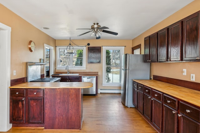 kitchen featuring ceiling fan, wood finished floors, stainless steel appliances, and light countertops