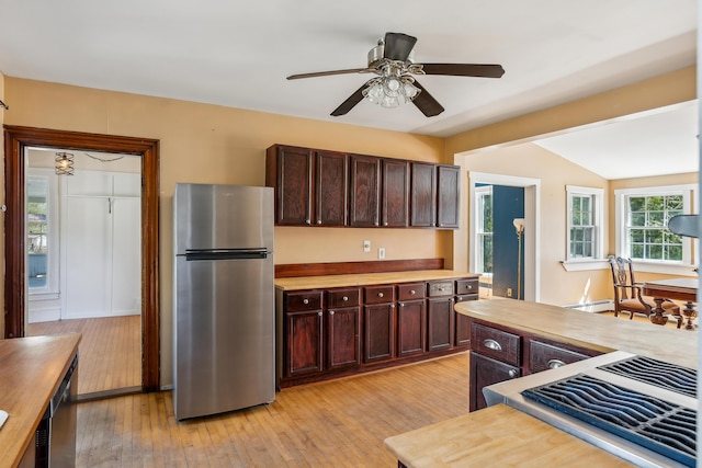 kitchen featuring a ceiling fan, a baseboard heating unit, light wood-type flooring, dark brown cabinetry, and appliances with stainless steel finishes