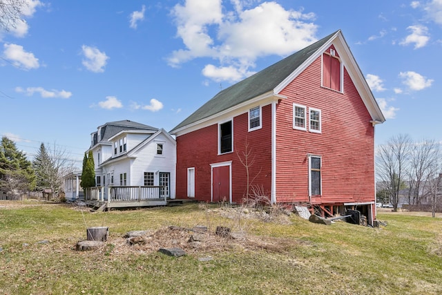 view of home's exterior featuring a yard and a deck