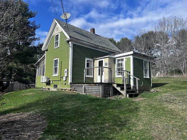 view of property exterior featuring a yard, a chimney, and fence