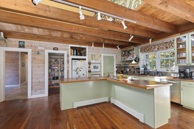 40 Mountain St, Camden, ME 04843 - kitchen with stainless steel dishwasher, open shelves, a baseboard heating unit, dark wood-type flooring, and freestanding refrigerator
