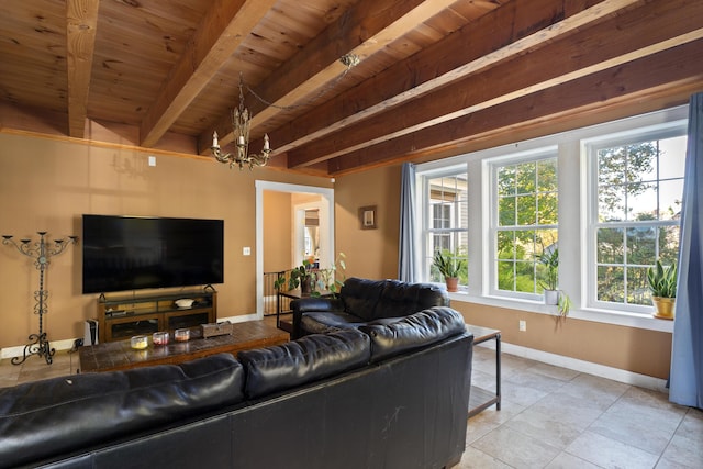 40 Mountain St, Camden, ME 04843 - living area with an inviting chandelier, baseboards, beam ceiling, and a healthy amount of sunlight