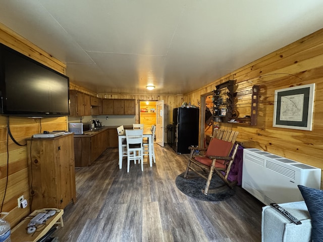 448 N Rd, Medford, ME 04463 - kitchen with stainless steel microwave, dark wood finished floors, freestanding refrigerator, brown cabinetry, and wooden walls