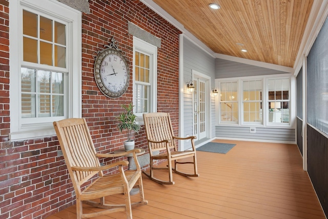 sunroom with wood ceiling, brick wall, and hardwood / wood-style flooring
