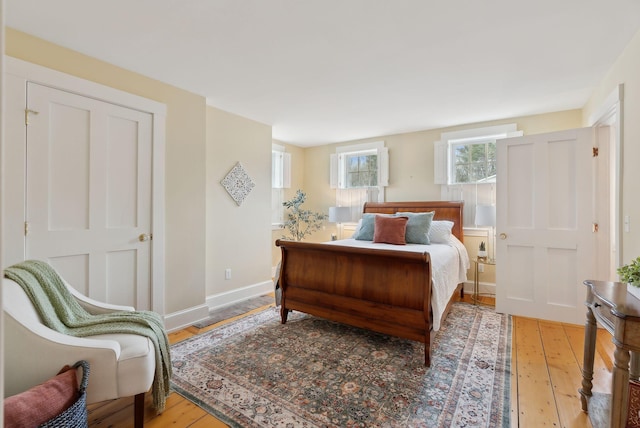 bedroom with baseboards and hardwood / wood-style flooring