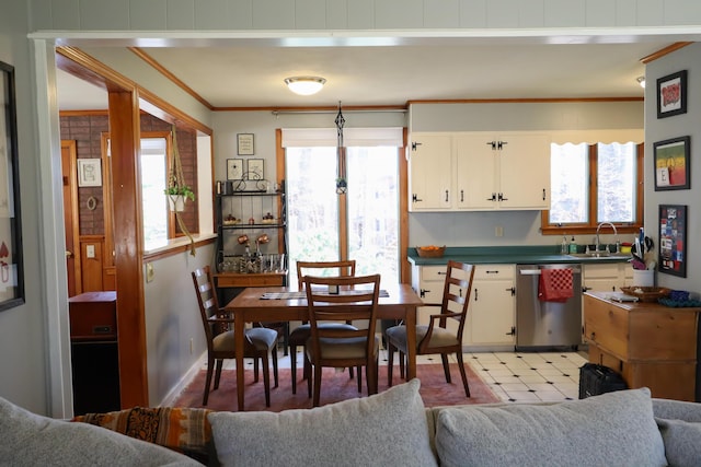 dining room with light floors and crown molding