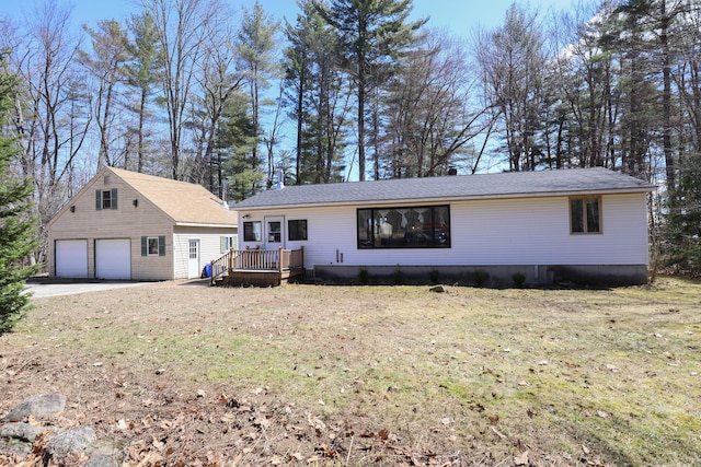 view of front of home featuring a front lawn, an outbuilding, a deck, and a garage