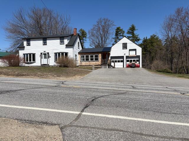 49 Pequawket Trl, Baldwin, ME 04024 - view of front of house with driveway and a chimney