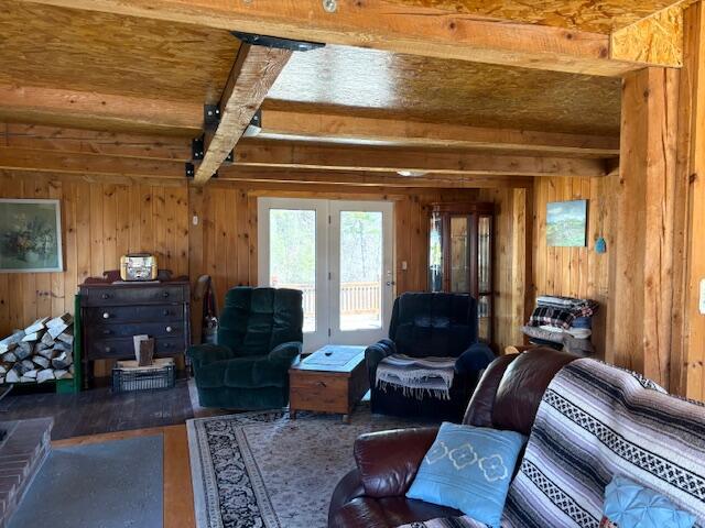49 Pequawket Trl, Baldwin, ME 04024 - living room featuring wood ceiling, wooden walls, french doors, and beamed ceiling