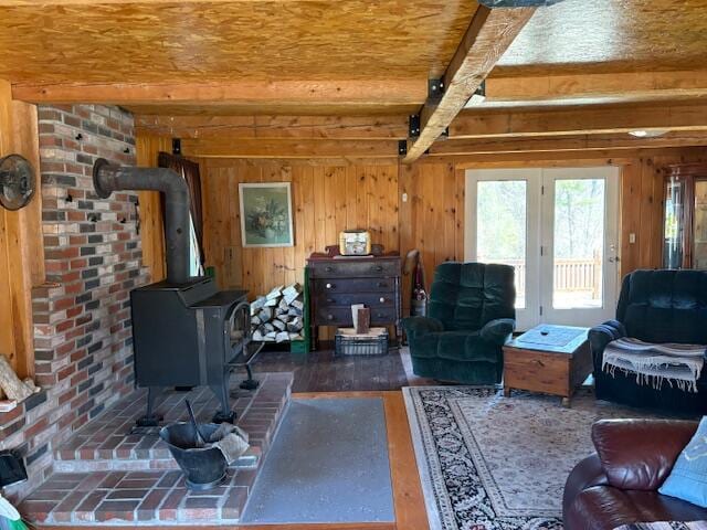 49 Pequawket Trl, Baldwin, ME 04024 - living area with beamed ceiling, a wood stove, and wood walls