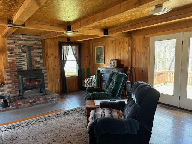 49 Pequawket Trl, Baldwin, ME 04024 - living area with beamed ceiling, wood finished floors, and a wood stove