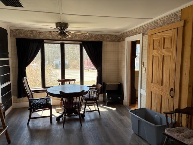 49 Pequawket Trl, Baldwin, ME 04024 - dining space with dark wood finished floors, a ceiling fan, wallpapered walls, and visible vents