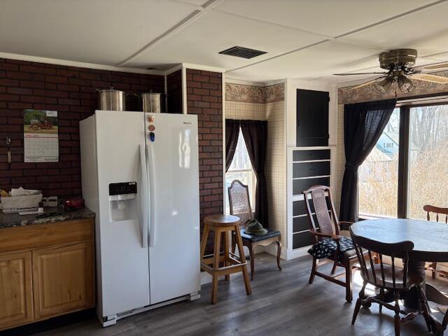 49 Pequawket Trl, Baldwin, ME 04024 - kitchen featuring ceiling fan, dark wood-style floors, visible vents, white refrigerator with ice dispenser, and brick wall