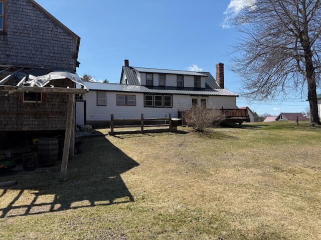 49 Pequawket Trl, Baldwin, ME 04024 - rear view of house with fence, a chimney, and a yard