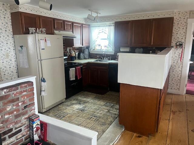 kitchen with wallpapered walls, light wood-type flooring, under cabinet range hood, and black appliances