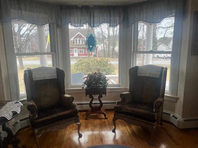 sitting room featuring baseboard heating and wood finished floors