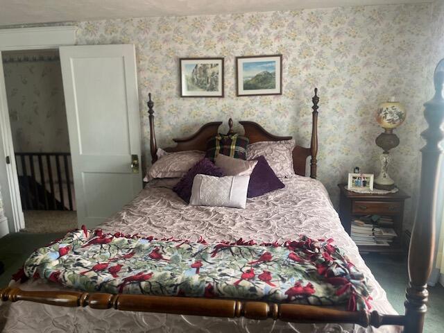 bedroom featuring carpet flooring and wallpapered walls