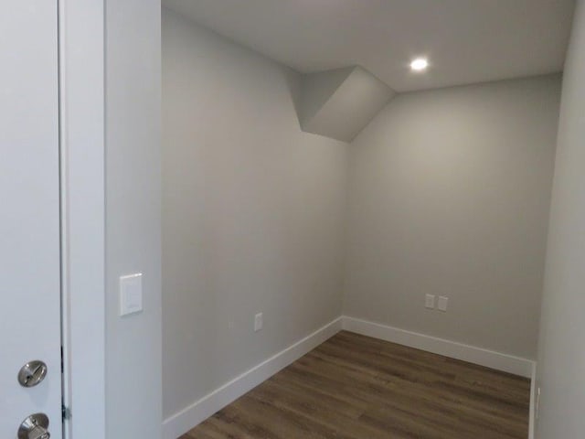 additional living space with recessed lighting, dark wood-style floors, and baseboards