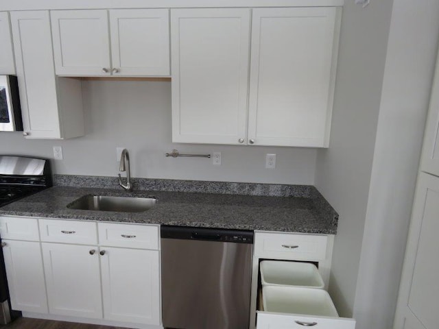 kitchen featuring dishwasher, a sink, white cabinetry, and stove
