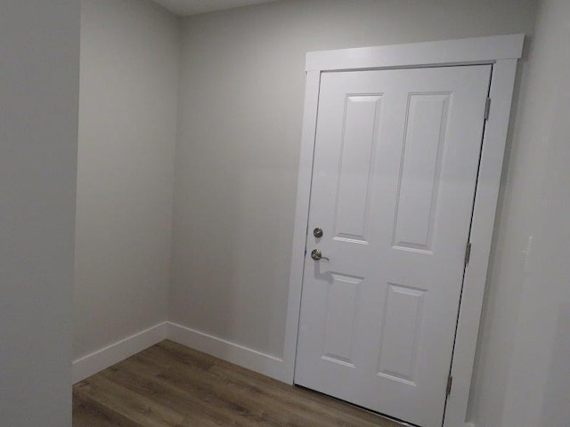 doorway to outside featuring wood finished floors and baseboards