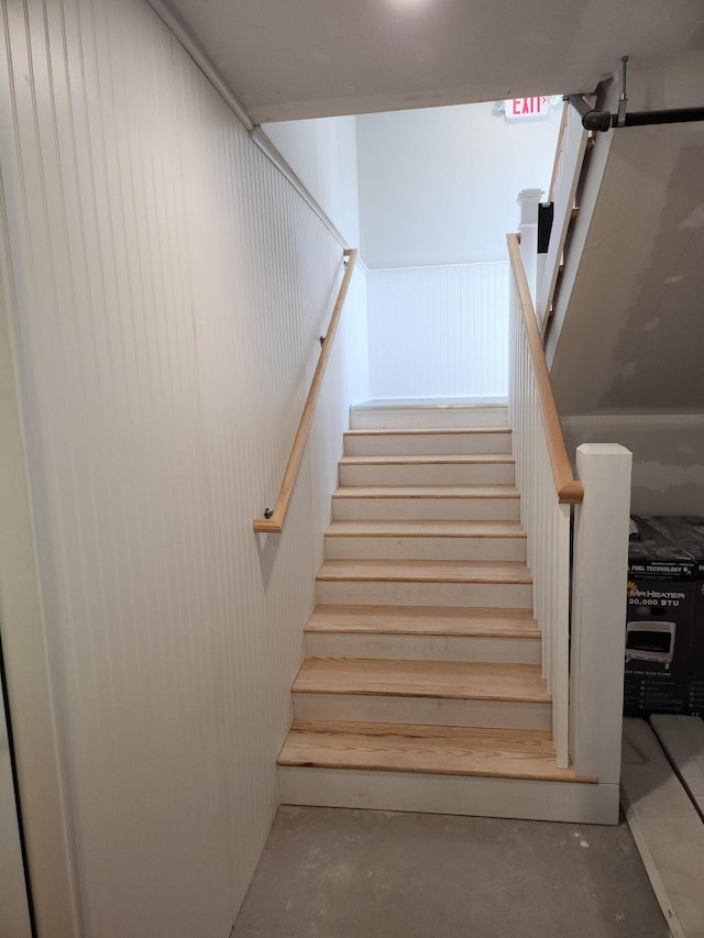 staircase with concrete flooring