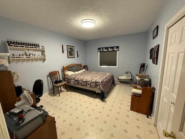 182 E Main St, Fort Kent, ME 04743 - bedroom with a textured ceiling, light floors, and baseboards