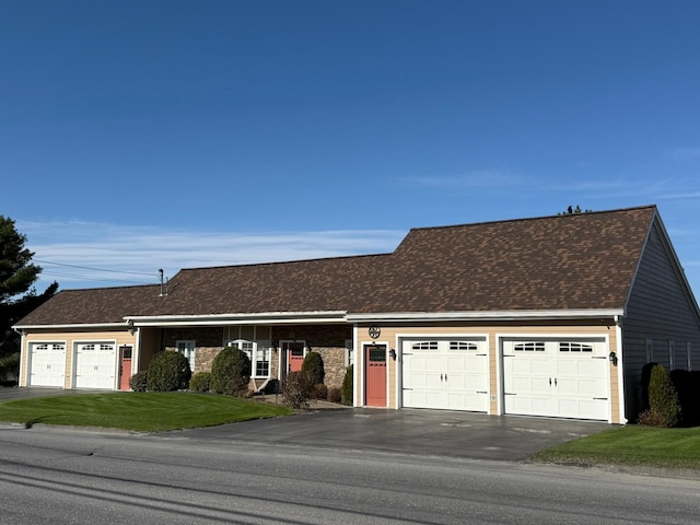 182 E Main St, Fort Kent, ME 04743 - view of front facade with a front lawn, an attached garage, asphalt driveway, and a shingled roof