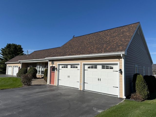 182 E Main St, Fort Kent, ME 04743 - view of front facade featuring a garage, asphalt driveway, and roof with shingles