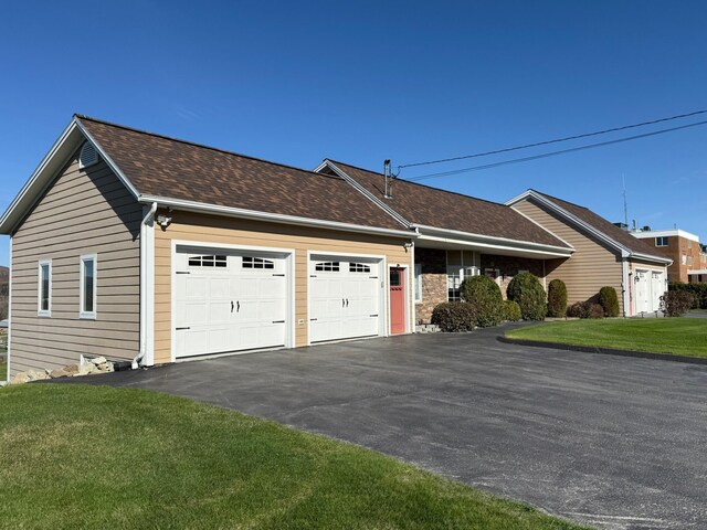 182 E Main St, Fort Kent, ME 04743 - view of home's exterior with a garage, driveway, a lawn, and roof with shingles