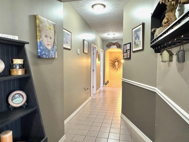 182 E Main St, Fort Kent, ME 04743 - corridor with a textured ceiling, tile patterned flooring, and baseboards