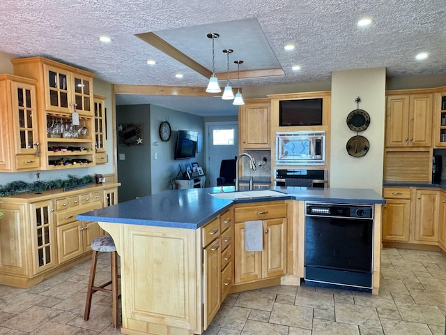 182 E Main St, Fort Kent, ME 04743 - kitchen with appliances with stainless steel finishes, a sink, stone tile flooring, a kitchen island with sink, and dark countertops