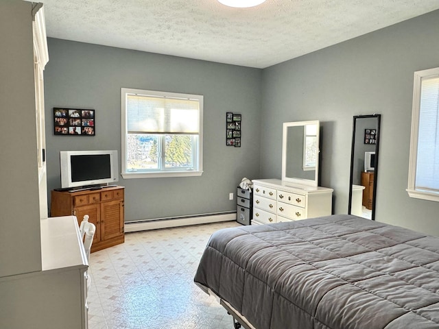 182 E Main St, Fort Kent, ME 04743 - bedroom with baseboard heating, multiple windows, light flooring, a textured ceiling, and baseboards