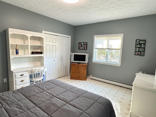 182 E Main St, Fort Kent, ME 04743 - bedroom with a baseboard heating unit, light flooring, a textured ceiling, a closet, and baseboards