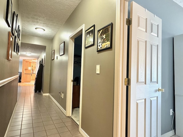 182 E Main St, Fort Kent, ME 04743 - hallway featuring a textured ceiling, light tile patterned floors, and baseboards