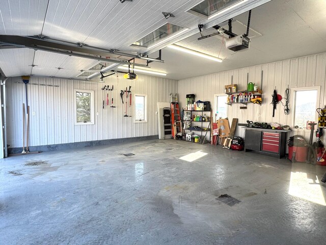 182 E Main St, Fort Kent, ME 04743 - garage with a garage door opener and a workshop area