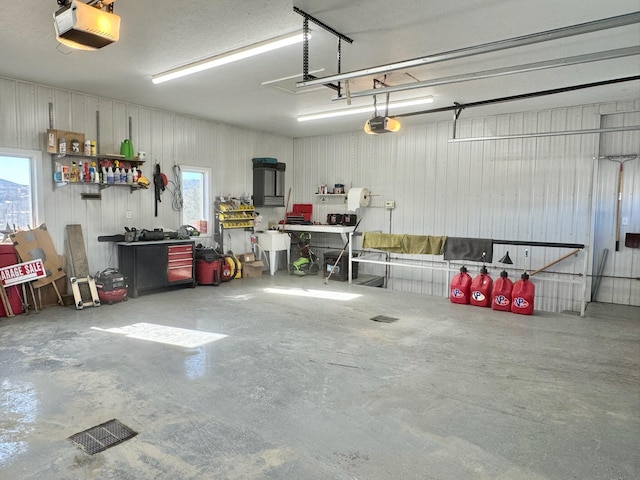 182 E Main St, Fort Kent, ME 04743 - garage with a garage door opener and a workshop area