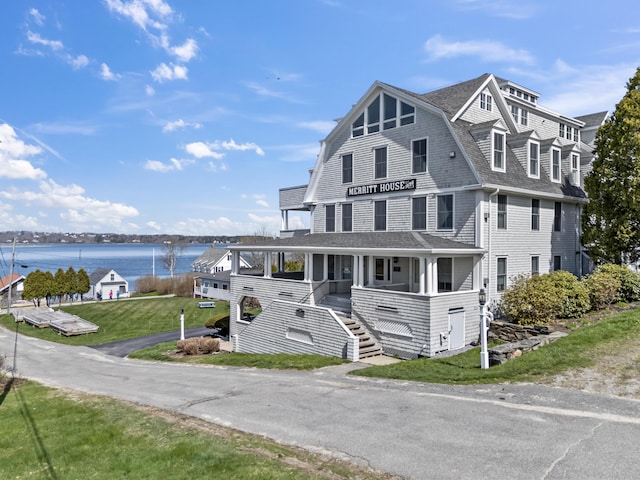 6 Merritt House Rd Unit 20, Harpswell, ME 04066 - view of front facade with roof with shingles, a porch, a water view, stairs, and a gambrel roof