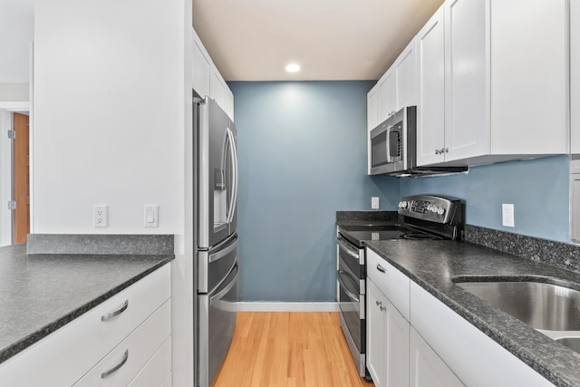 6 Merritt House Rd Unit 20, Harpswell, ME 04066 - kitchen with appliances with stainless steel finishes, white cabinetry, dark countertops, and recessed lighting