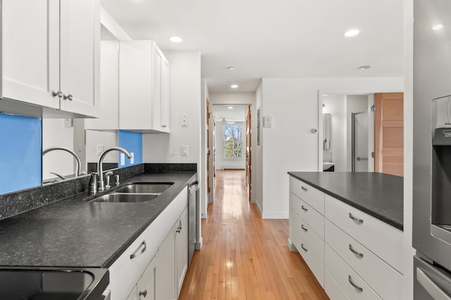 6 Merritt House Rd Unit 20, Harpswell, ME 04066 - kitchen featuring a sink, dishwasher, white cabinets, light wood-style floors, and stove