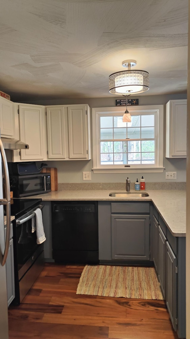 54 Black Smith Rd Unit 13, Wells, ME 04090 - kitchen with a sink, light countertops, wood finished floors, gray cabinetry, and black appliances