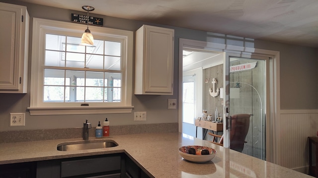 54 Black Smith Rd Unit 13, Wells, ME 04090 - kitchen featuring white cabinetry, decorative light fixtures, and a sink