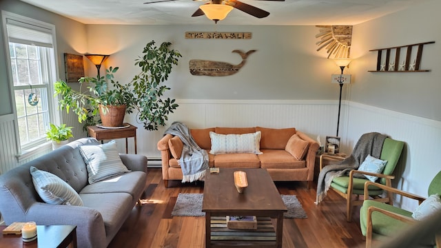 54 Black Smith Rd Unit 13, Wells, ME 04090 - living area featuring wood finished floors, a ceiling fan, a baseboard heating unit, and a wainscoted wall