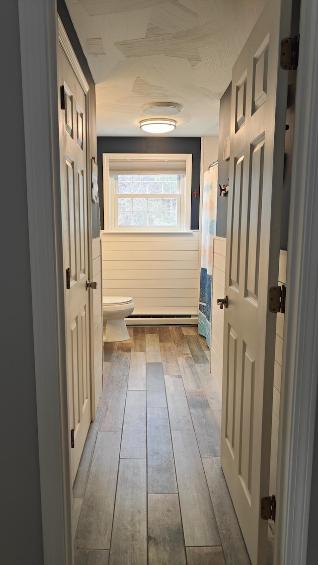 54 Black Smith Rd Unit 13, Wells, ME 04090 - interior space featuring hardwood / wood-style floors, toilet, and a shower with curtain