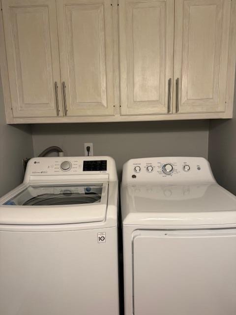 54 Black Smith Rd Unit 13, Wells, ME 04090 - washroom featuring separate washer and dryer and cabinet space